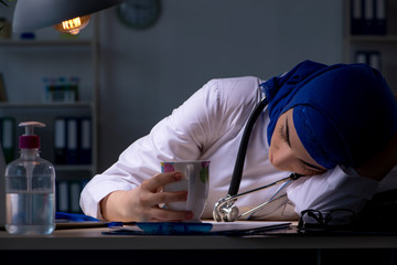 Arab female doctor working in the clinic at night