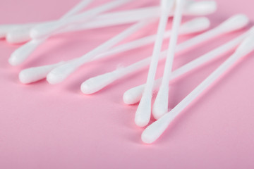 sticks for cleaning ears on a pink background