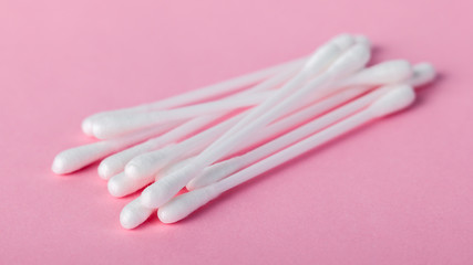 sticks for cleaning ears on a pink background