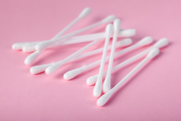 sticks for cleaning ears on a pink background