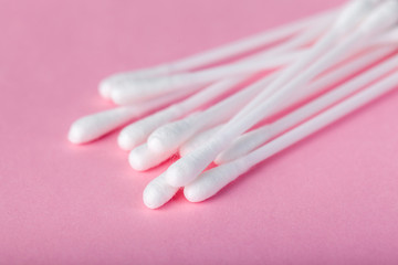 sticks for cleaning ears on a pink background