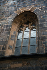 Arched window with grate of Prague temple
