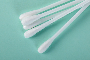 sticks for cleaning ears on a green background