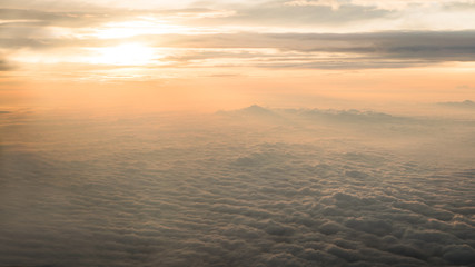 Fototapeta na wymiar Aerial traveling. Flying at dusk or dawn. Fly through orange cloud and sun.