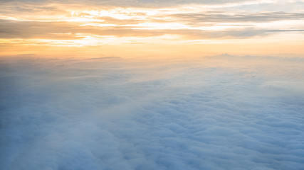 Aerial traveling. Flying at dusk or dawn. Fly through orange cloud and sun.