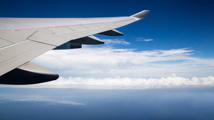 Obraz premium Traveling by air. Plane wing in flight. Beautiful sky and wonderful clouds