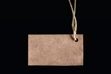 Blank label on a black background, tag attached to the product rope, shows the price or discount
