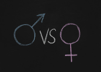 Male gender symbol vs female on chalkboard