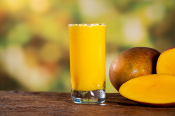 Fresh mango juice and mango fruit with a natural backdrop.