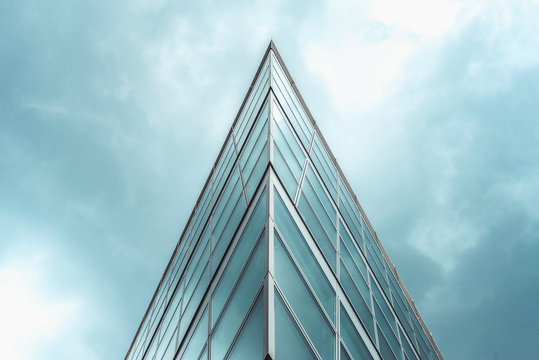 triangle shaped structure against a blue cloudy sky.