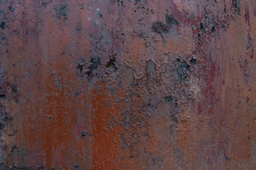 Macro texture of peeled paint on rusty iron closeup.