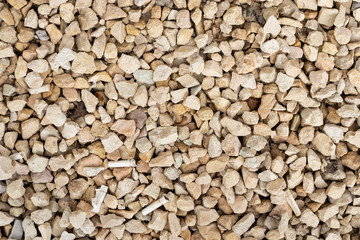 Macro texture of white gravel and concrete slab in half.