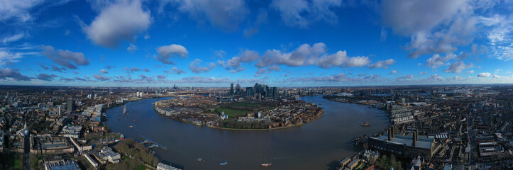 Aerial bird's eye view panoramic drone photo of Greenwich park with views to Canary Wharf and University of Greenwich with beautiful cloudy sky, Isle of Dogs, London, United Kingdom