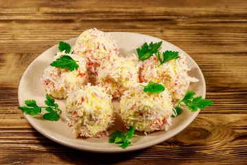 Appetizer of crab-cheese balls on wooden table
