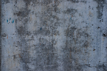 Macro texture of peeled paint on a white concrete wall.