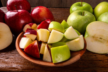 Ripe red and green apples on table close up