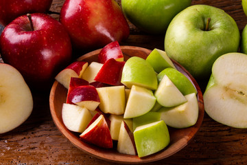 Ripe red and green apples on table close up