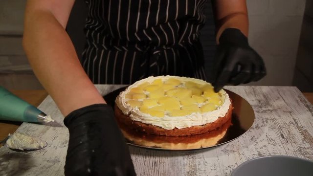 Assembling the nut-banana cake layers, smearing with syrup, applying butter cream, filling the filling, the whole process of making the cake, stock footage
