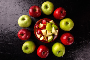 Ripe red and green apples on table close up