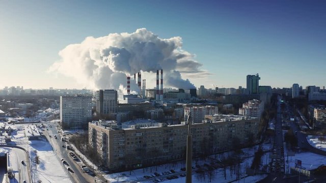 power plant pipes on the background of the panorama of the winter city against blue sky. Leninsky prospectus and monument to Gagarin Yuri Alekseevich