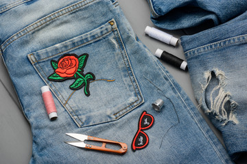 Applying embroidered patches to jeans