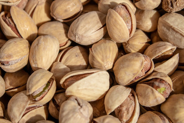 salty delicious open pistachios in a bowl. brown natural background from natural nuts