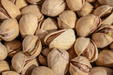 salty delicious open pistachios in a bowl. brown natural background from natural nuts