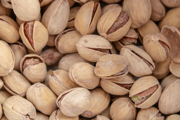 salty delicious open pistachios in a bowl. brown natural background from natural nuts