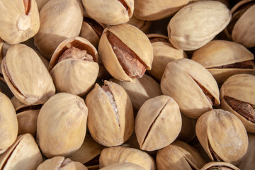 salty delicious open pistachios in a bowl. brown natural background from natural nuts