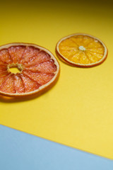  dried citruses on a yellow background