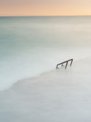 view of minimalist stairway to the sea in long exposure photography
