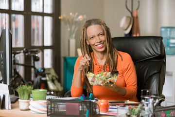 Stylish Woman with Drealocks Eating a Healthy Lunch at her Desk