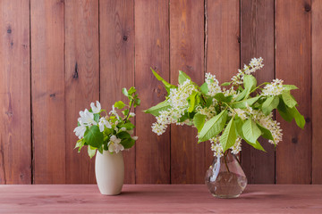 Home interior with decor elements. White spring flowers in a vase on a wooden table