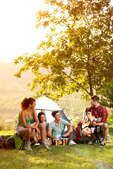 young people on camping trip to play and sing - obrazy, fototapety, plakaty