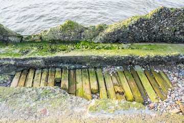 Fototapeta premium Destroyed coastal concrete protective structure.