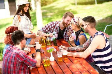 Youngsters play cards, laughing and joking in nature