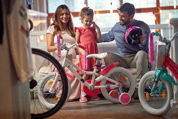 Obraz na płótnie Canvas happy family with child buying new bicycle.