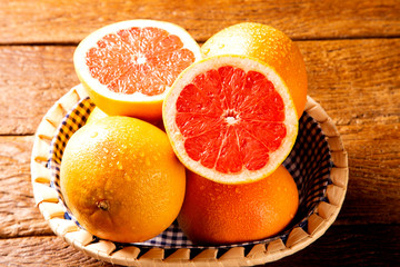 Freshly red grapefruit on wooden background