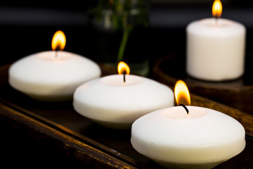 three candles on black background