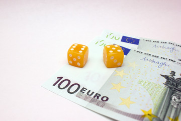 Amber dices and euro banknotes on white background isolated