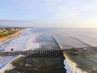 Aerial view of San Clemente Pier with beach and coastline. San Clemente city in Orange County, California, USA. Travel destination in the South West Coast. Famous beach for surfer.