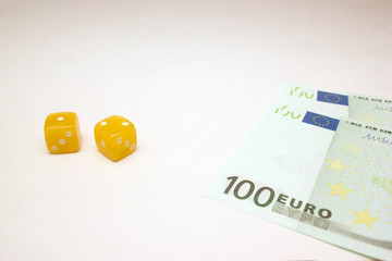 Amber dices and euro banknotes on white background isolated