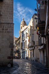 Fototapeta premium Malaga early morning downtown street view with church tower and blue sky in Spain