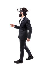 Obraz premium Full length portrait of a bearded businessman in virtual reality glasses, presses invisible buttons, isolated on white background