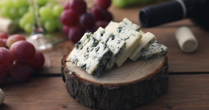 blue cheese on wood log slice