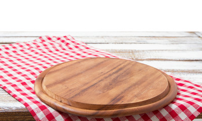 Round wood pizza cutting board and tablecloth on wooden table isolated on white background. Top view and copy space, Empty and template mockup with place for food.