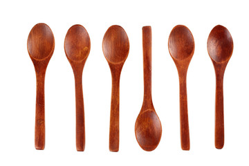Top view of a set of six wooden spoons made of dark wood, isolated on a white background
