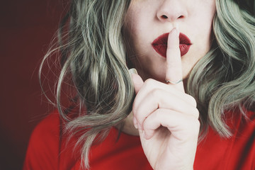 Elegant young woman doing silent gesture