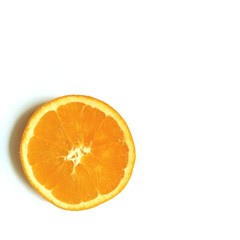 flatlay layout slice of orange in the center of white background