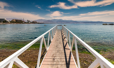 Fototapeta na wymiar View on the Red Sea from swimming footpath at central public beach of Eilat - famous resort and recreational city in Israel and Middle East